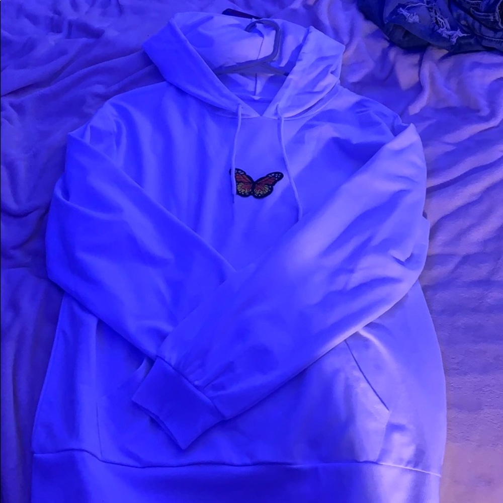 White hoodie with butterfly in the middle of it